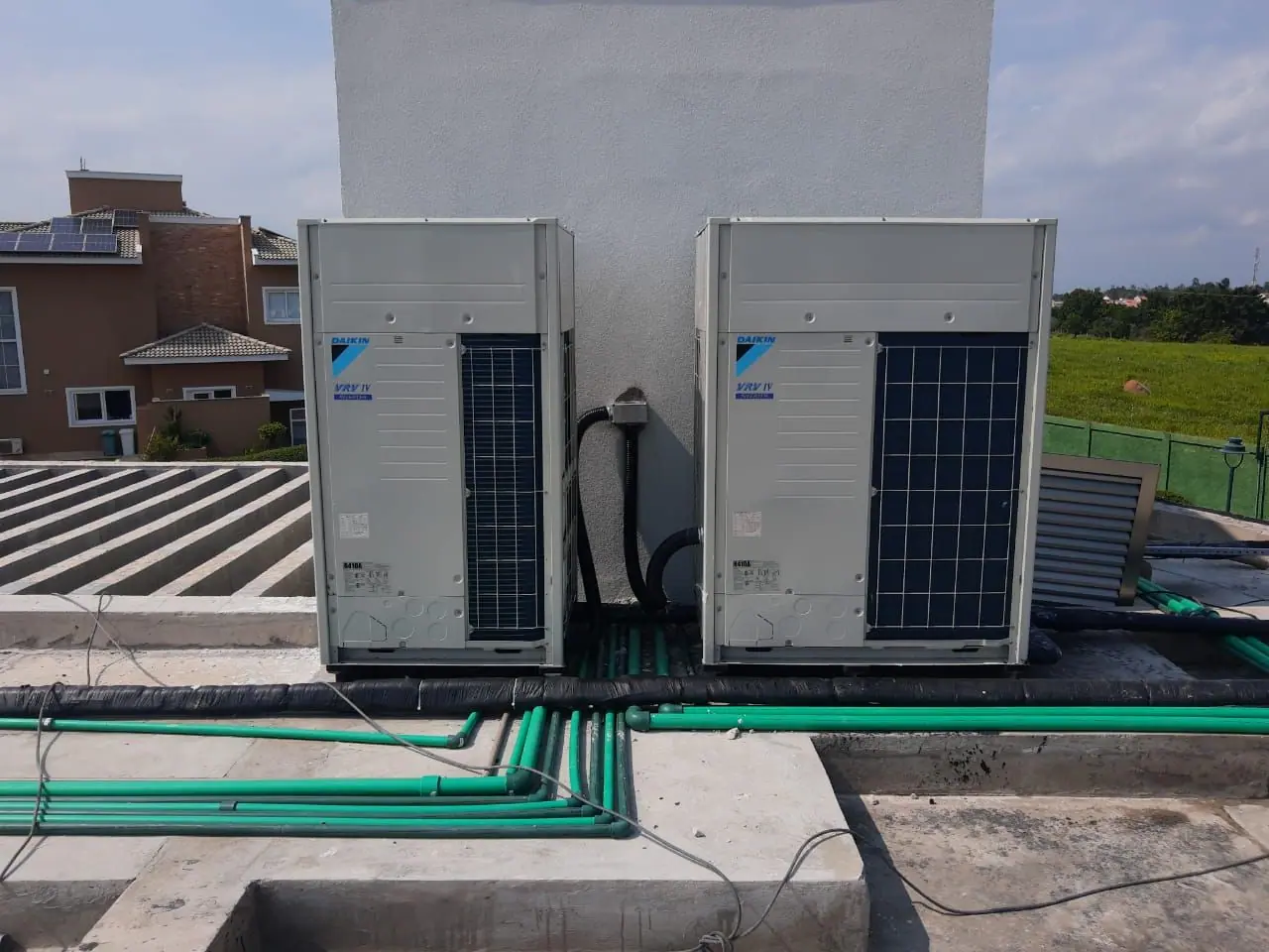 Two large VRF outdoor units on a rooftop with refrigerant piping